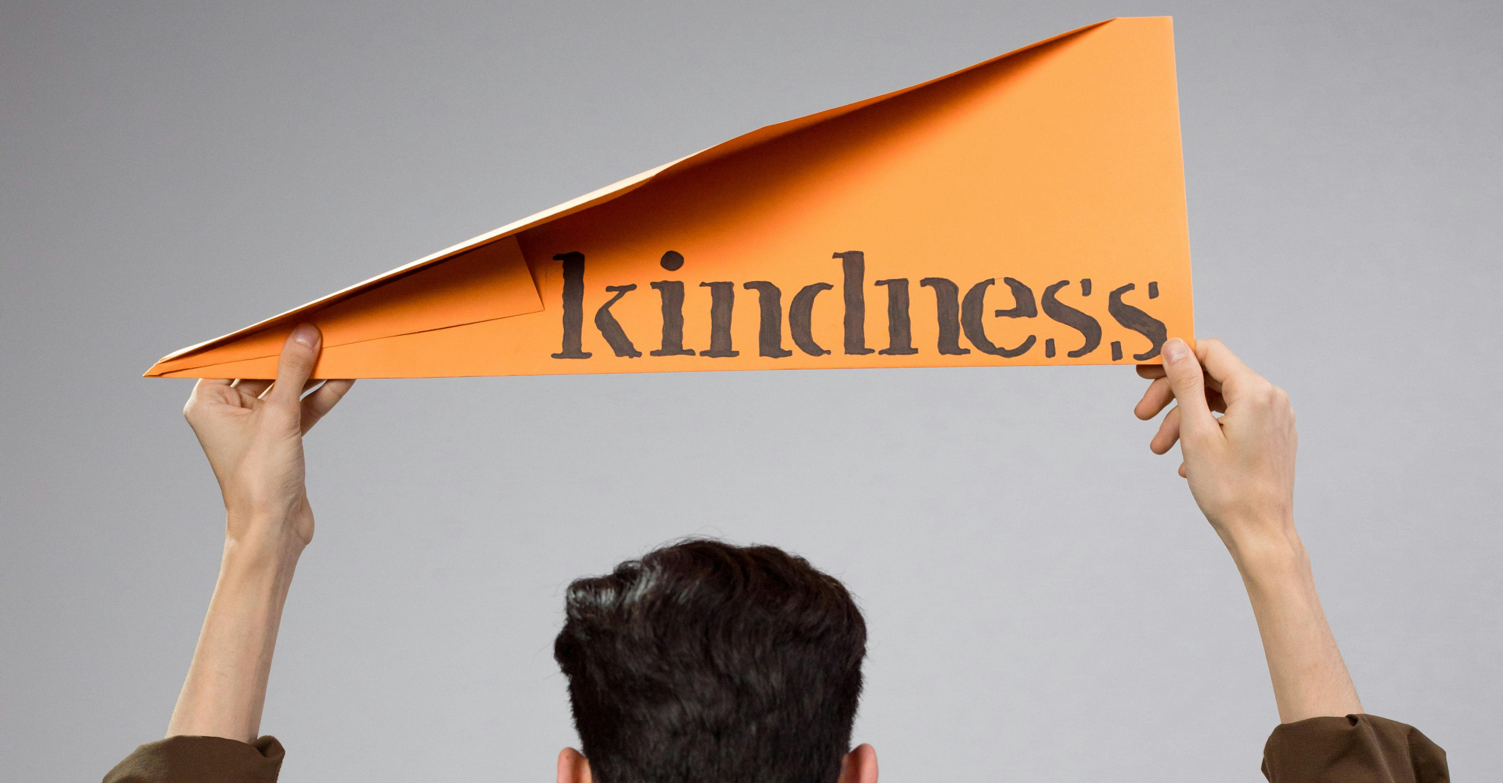Men showing the kindness banner